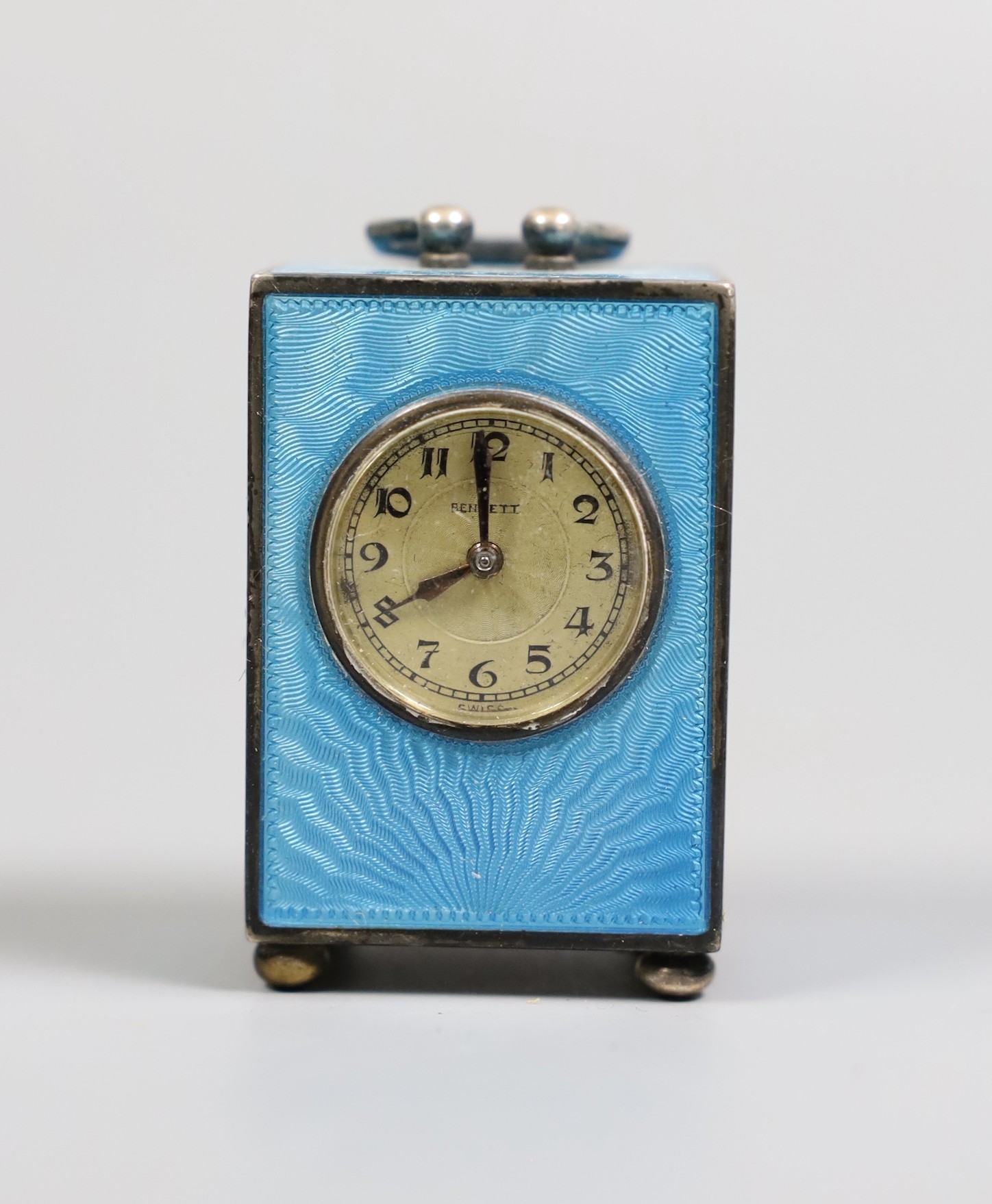 A George V Swiss blue enamel and silver cased miniature carriage timepiece, import marks for Arthur George Rendell, London, 1924, 43mm, on bun feet, in gilt tooled leather carrying case